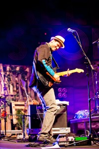 Trevor Larkin shredding his guitar in front of one of the Vertical Pallet Gardens and the FiKusFunk Stand!